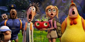flint lockwood and sam hold a strawberry. cloudy with a chance of meatballs 2