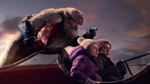 Santa Claus shows Kate and Teddy how to ride his sleigh. The Christmas Chronicles.