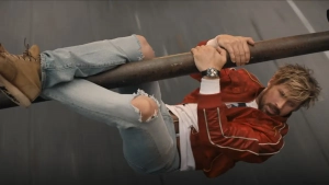 ryan gosling holding on to a beam in the fall guy movie